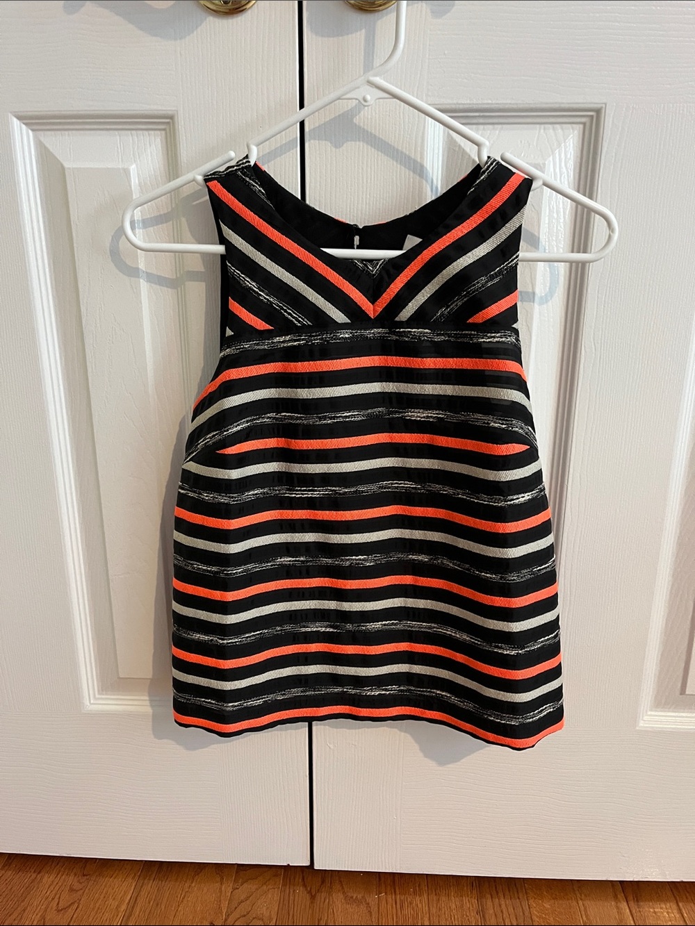 Black, white, and orange horizontal striped tank top